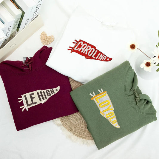 College hoodie with embroidered team name pennant